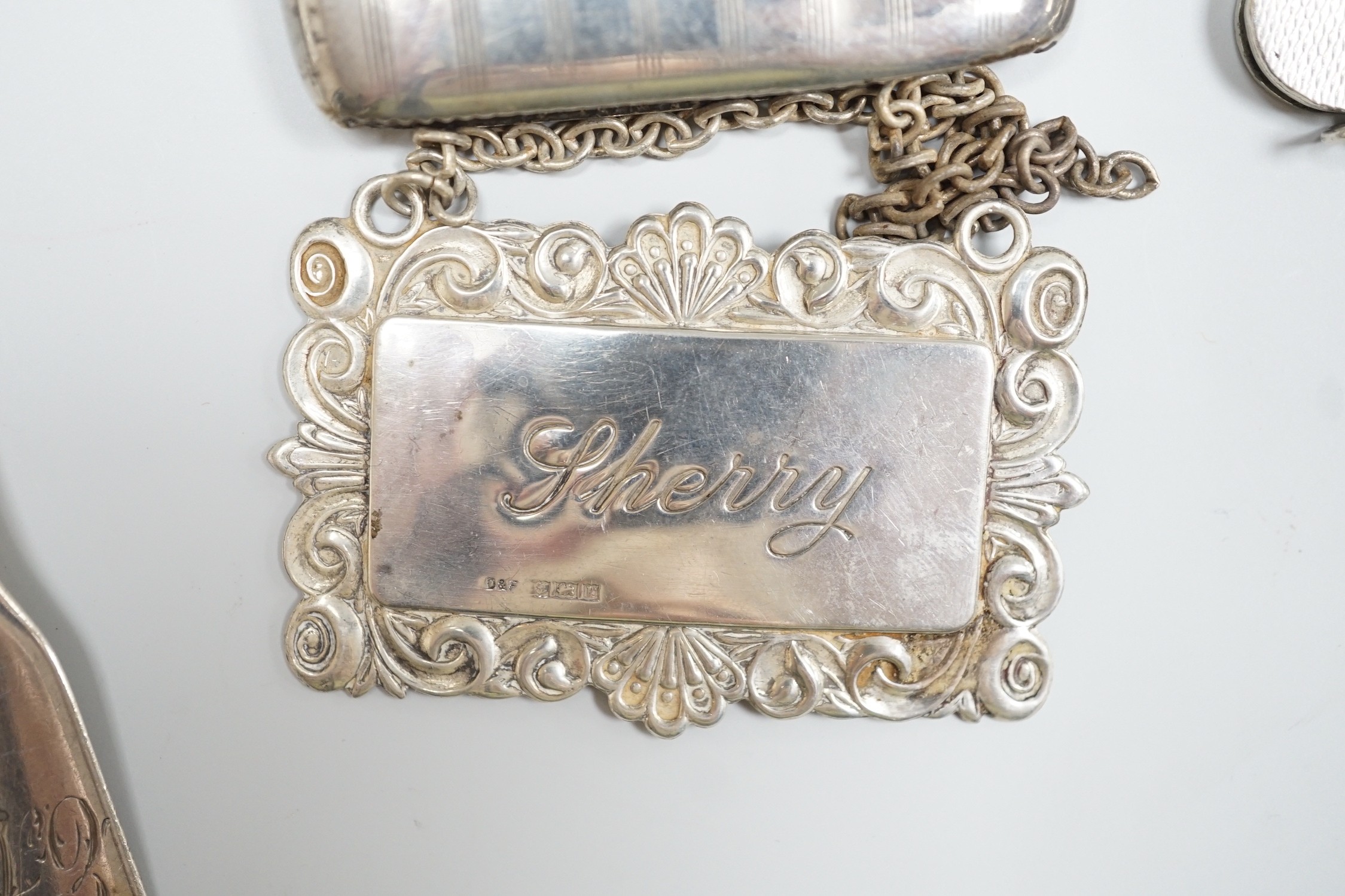 Sundry small silver including a George V goblet, cigarette case, vesta cases, flatware, wine labels and napkin rings including plated.